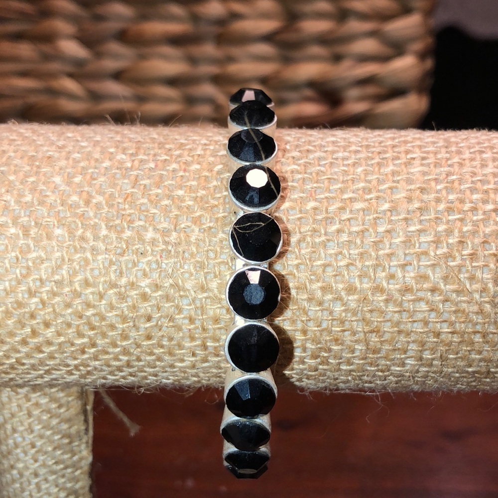 Black stones encased in silver bangle